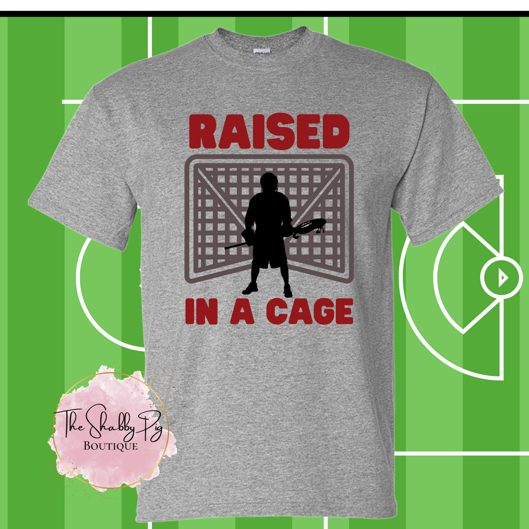 Lacrosse Raised in a Cage Graphic Tee